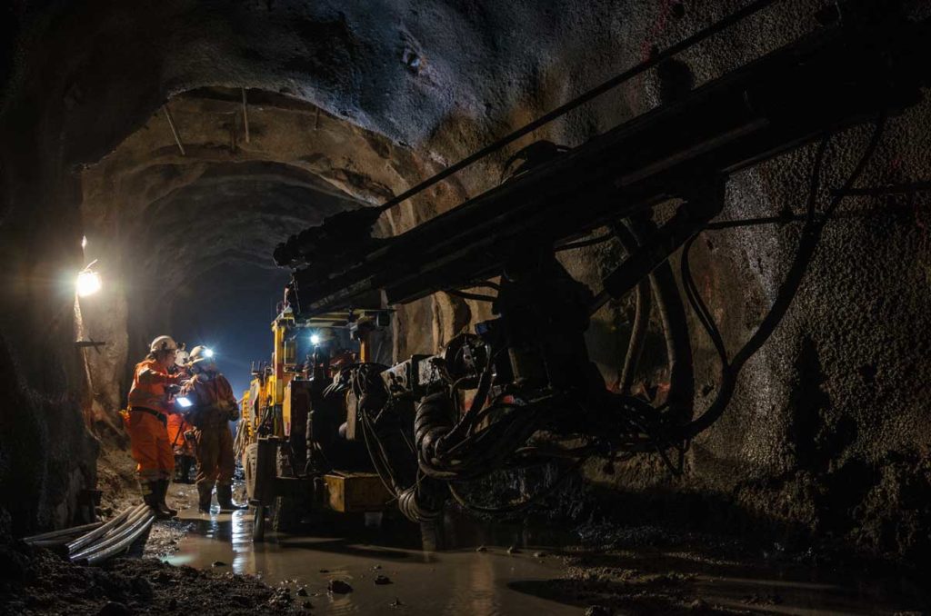 Mining operation with heavy equipment, utilizing Fisher Barton wear-resistant components for extreme durability.